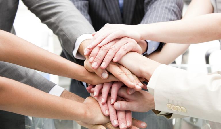 Close-up of a multi-ethnic partners with hands together