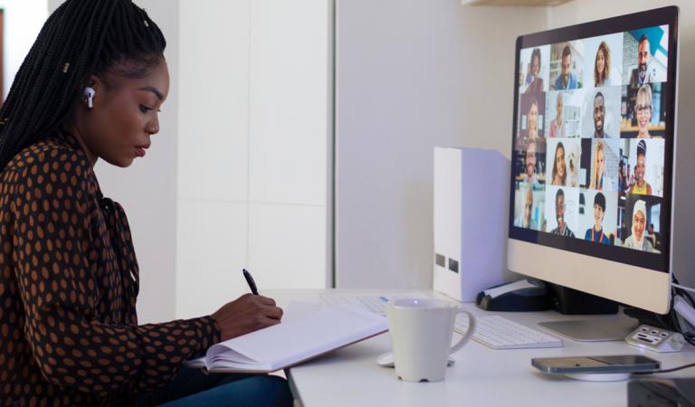 Young African businesswoman working from her home trough video conferencing during coronavirus lockdown
