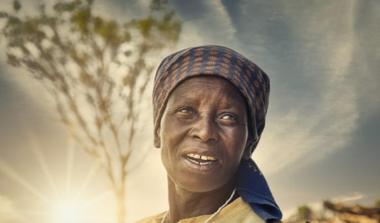 Portrait of an old African woman at sunset